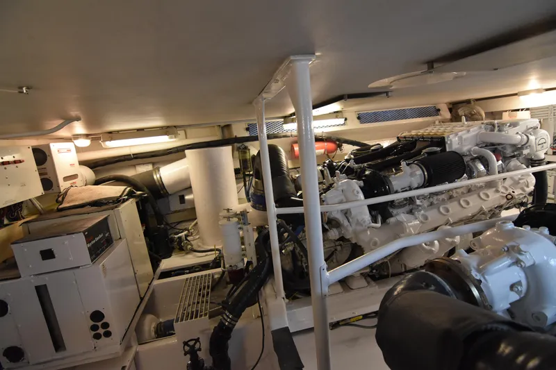 Legacy Yacht Photos Pics Engine room of a 1999 Viking 58 Convertible yacht, showcasing machinery and equipment.