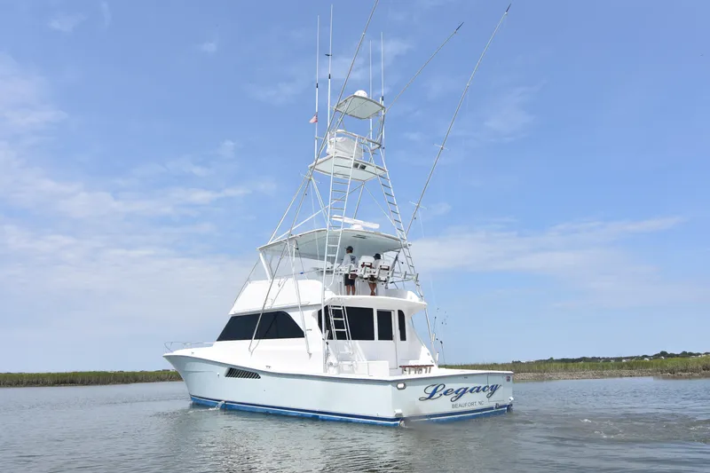 Legacy Yacht Photos Pics 1999 Viking 58 Convertible yacht on calm water under clear blue sky.