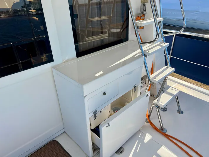 Yacht Photos Pics 2008 Island Pilot 435 yacht interior with open storage cabinet and metal ladder.