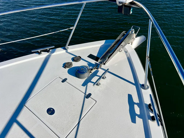  Yacht Photos Pics Bow of 2008 Island Pilot 435 yacht with anchor and railing, on calm water.