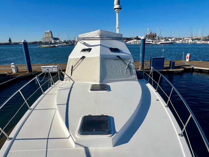  Yacht Photos Pics 2008 Island Pilot 435 yacht docked at marina, clear blue sky, calm water.