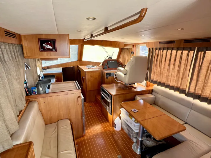  Yacht Photos Pics Interior of 2008 Island Pilot 435 yacht with wood finishes and cozy seating area.