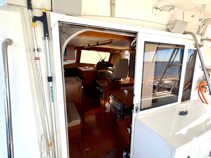  Yacht Photos Pics Interior view of 2008 Island Pilot 435 yacht, showcasing helm and seating area.