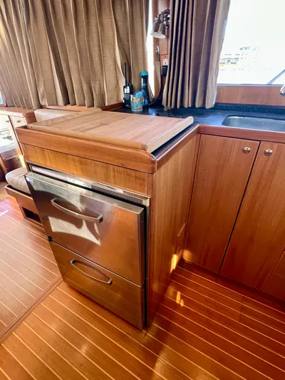  Yacht Photos Pics 2008 Island Pilot 435 yacht kitchen with wood cabinetry and stainless steel appliances.