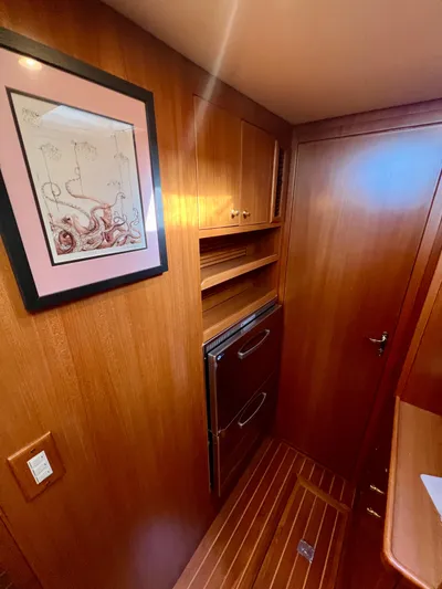  Yacht Photos Pics Interior of 2008 Island Pilot 435 yacht with wood paneling and framed artwork.