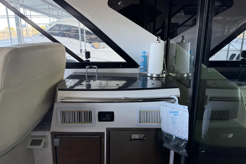  Yacht Photos Pics 2012 Regal 46 Sport Coupe interior with kitchenette and storage area.