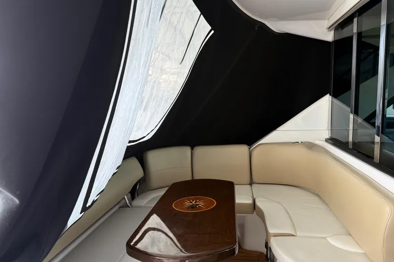  Yacht Photos Pics Interior of 2012 Regal 46 Sport Coupe with beige seating and wooden table.