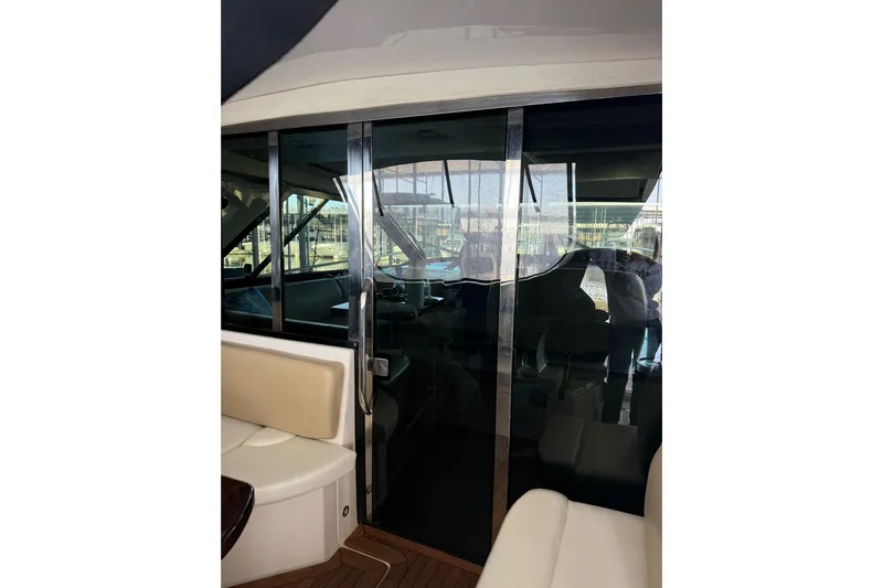  Yacht Photos Pics 2012 Regal 46 Sport Coupe interior with sliding glass doors and seating area.