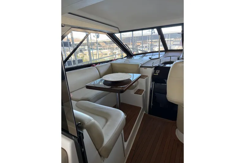  Yacht Photos Pics Interior of 2012 Regal 46 Sport Coupe with elegant seating and wooden table.