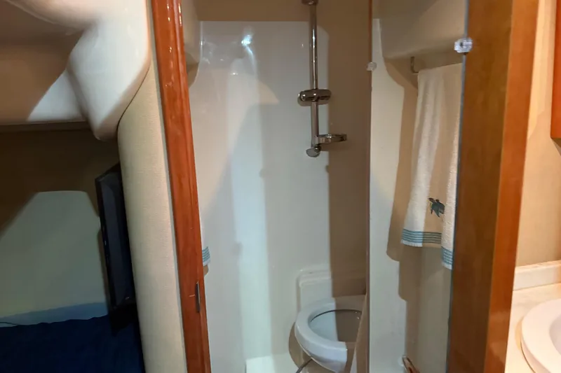  Yacht Photos Pics Bathroom interior of 2012 Regal 46 Sport Coupe yacht, featuring shower and toilet.