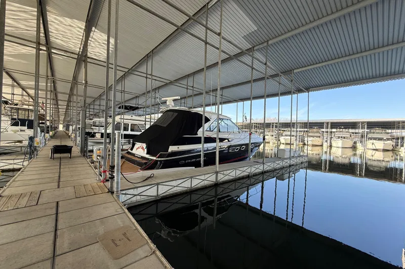 Yacht Photos Pics 2012 Regal 46 Sport Coupe docked in a covered marina with calm waters.