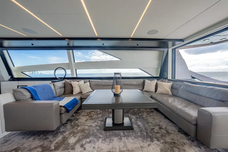 Vintage Yacht Photos Pics Luxurious interior of 2021 Pershing 9X yacht with modern seating and ocean view.