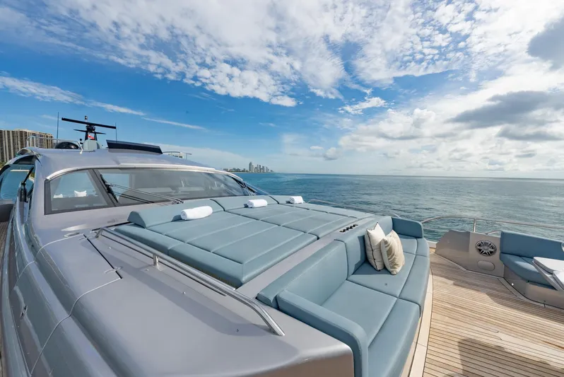 Vintage Yacht Photos Pics Luxury Pershing 9X yacht deck with sun loungers, ocean view, and blue sky, 2021 model.
