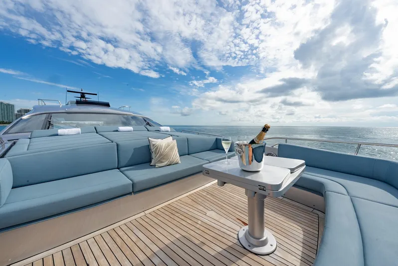 Vintage Yacht Photos Pics Luxurious 2021 Pershing 9X yacht deck with champagne, ocean view, and elegant seating.