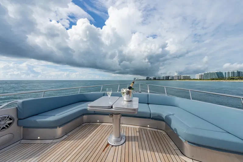 Vintage Yacht Photos Pics Luxurious 2021 Pershing 9X yacht deck with ocean view, featuring elegant seating and champagne.