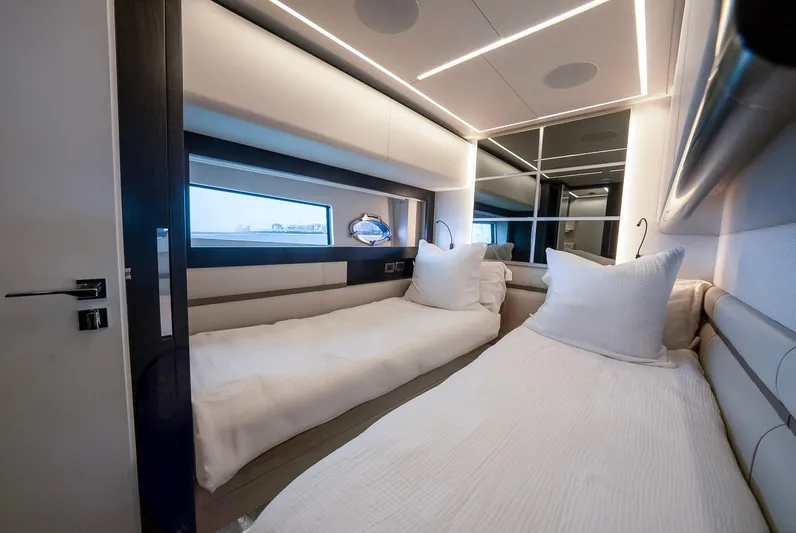 Vintage Yacht Photos Pics Luxurious twin bedroom interior on 2021 Pershing 9X yacht, featuring modern design and ambient lighting.