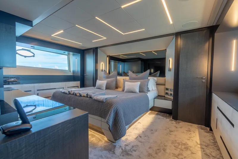 Vintage Yacht Photos Pics Luxurious bedroom interior of 2021 Pershing 9X yacht with modern design and ambient lighting.