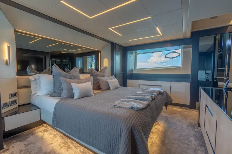 Vintage Yacht Photos Pics Luxurious bedroom interior of 2021 Pershing 9X yacht with modern design and ocean view.
