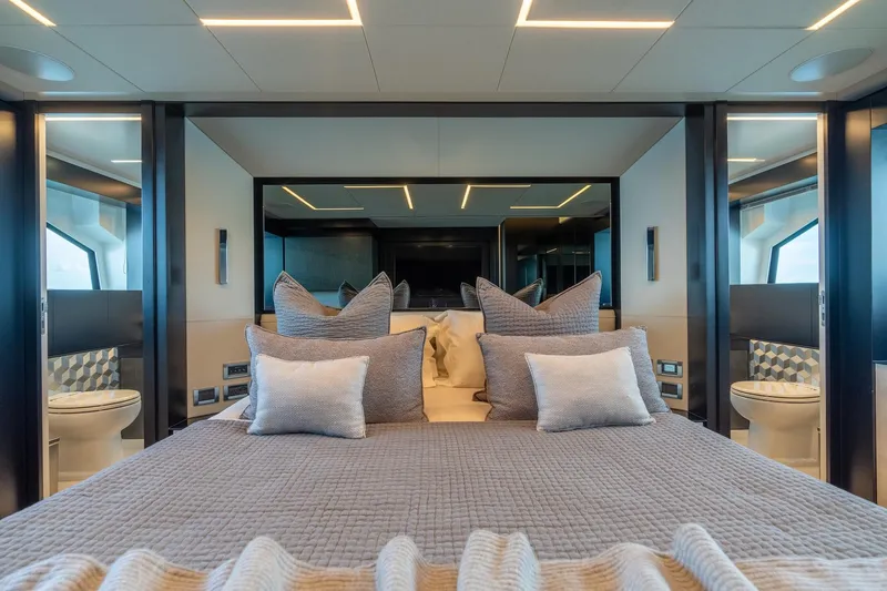 Vintage Yacht Photos Pics Luxurious bedroom interior on 2021 Pershing 9X yacht, featuring elegant bedding and modern design.