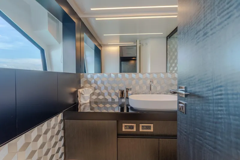 Vintage Yacht Photos Pics Luxurious bathroom interior on 2021 Pershing 9X yacht, featuring modern sink and geometric tiles.