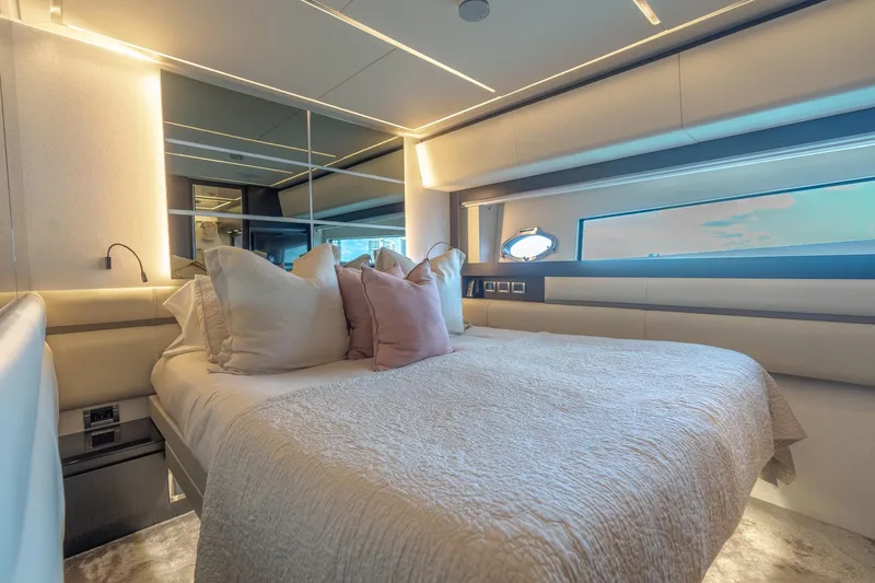 Vintage Yacht Photos Pics Luxurious bedroom interior of 2021 Pershing 9X yacht with modern design and plush bedding.
