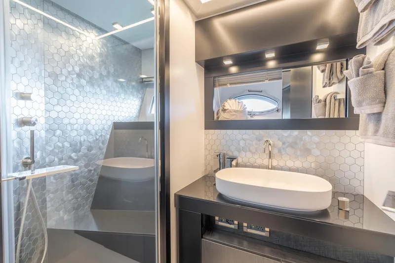 Vintage Yacht Photos Pics Luxurious bathroom in 2021 Pershing 9X yacht with modern hexagonal tile design.