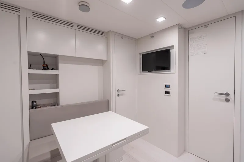 Vintage Yacht Photos Pics Modern interior of 2021 Pershing 9X yacht with sleek white furnishings and compact design.