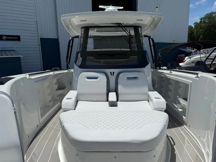  Yacht Photos Pics 2025 Wellcraft 38 T-Top boat interior with white seating and modern design.