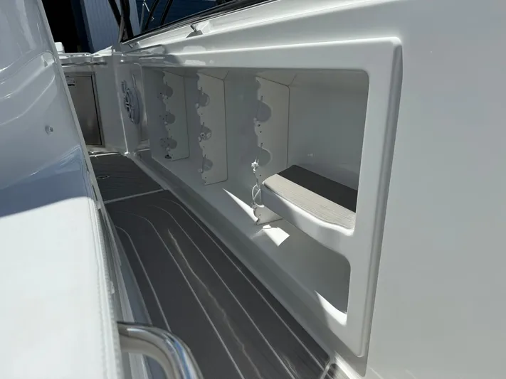  Yacht Photos Pics 2025 Wellcraft 38 T-Top boat interior with storage compartments and sleek design.