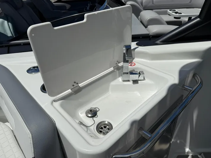  Yacht Photos Pics 2025 Wellcraft 38 T-Top boat sink with chrome faucet and white interior.