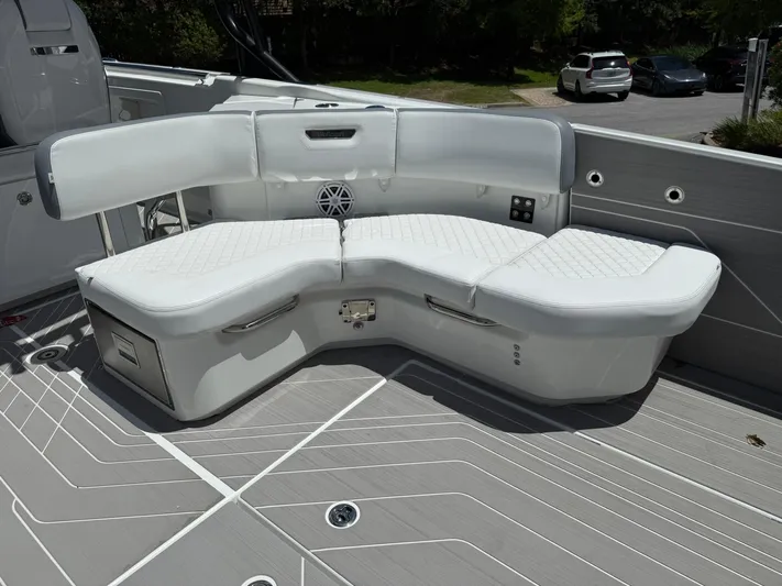  Yacht Photos Pics 2025 Wellcraft 38 T-Top boat with white cushioned seating and sleek deck design.