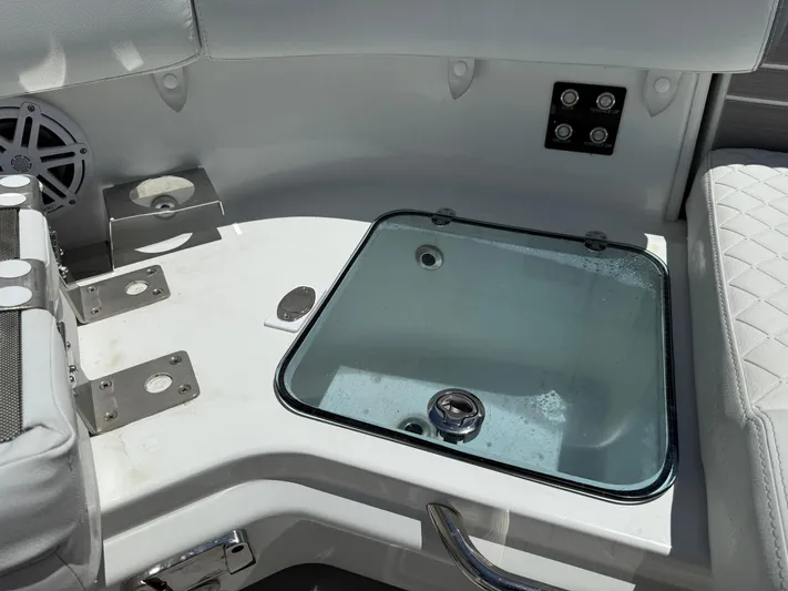  Yacht Photos Pics 2025 Wellcraft 38 T-Top boat interior with seating and storage compartment.