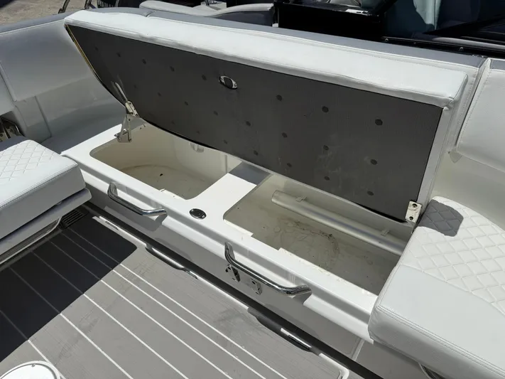  Yacht Photos Pics Open storage compartment on 2025 Wellcraft 38 T-Top boat with white seating.