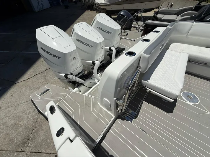  Yacht Photos Pics 2025 Wellcraft 38 T-Top boat with triple Mercury outboard engines, sleek deck design.