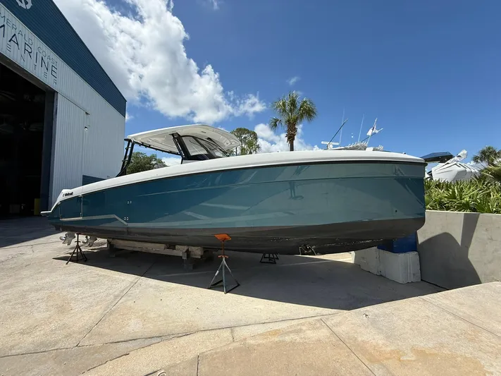  Yacht Photos Pics 2025 Wellcraft 38 T-Top boat on dry dock under a clear blue sky.