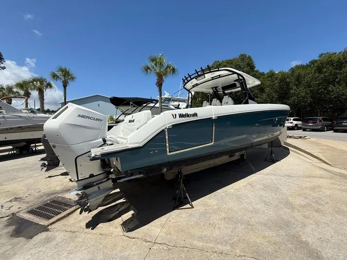  Yacht Photos Pics 2025 Wellcraft 38 T-Top boat with Mercury engines on display outdoors.
