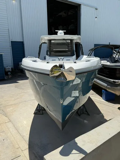  Yacht Photos Pics 2025 Wellcraft 38 T-Top boat in a marina, showcasing sleek design and modern features.