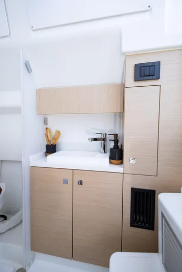  Yacht Photos Pics 2025 Wellcraft 38 T-Top boat interior with modern kitchenette and sleek cabinetry.