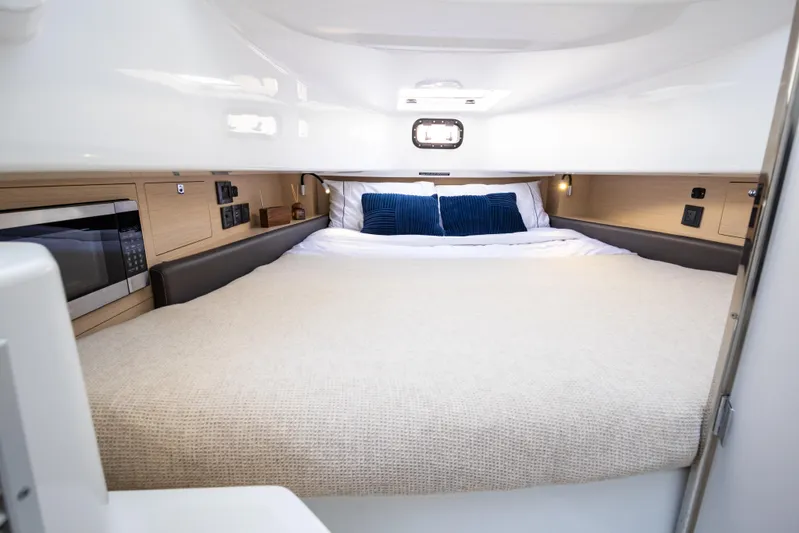  Yacht Photos Pics Interior cabin of 2025 Wellcraft 38 T-Top boat with bed and microwave.