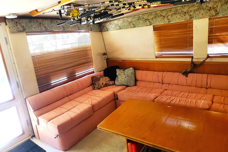 Trophy Hunter Yacht Photos Pics Interior of 1989 Bertram 50 Convertible with pink seating and fishing rods.