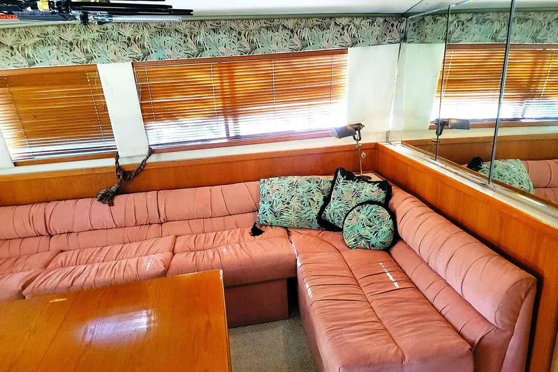 Trophy Hunter Yacht Photos Pics Interior of 1989 Bertram 50 Convertible with pink seating and tropical-themed cushions.