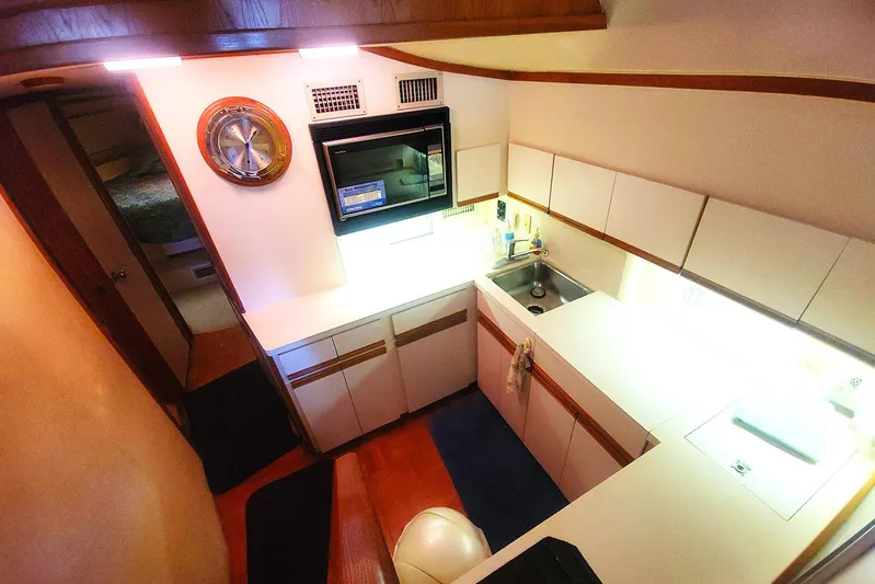 Trophy Hunter Yacht Photos Pics Interior of 1989 Bertram 50 Convertible yacht kitchen with modern amenities.