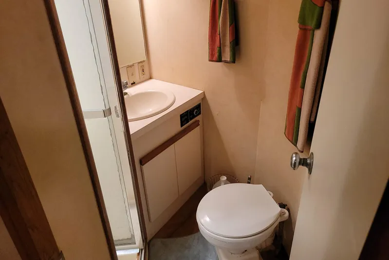 Trophy Hunter Yacht Photos Pics Bathroom interior of 1989 Bertram 50 Convertible yacht, featuring sink and toilet.