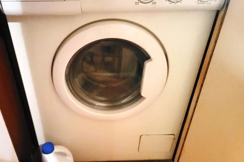 Trophy Hunter Yacht Photos Pics Front-loading washing machine in a compact laundry space on a 1989 Bertram 50 Convertible.