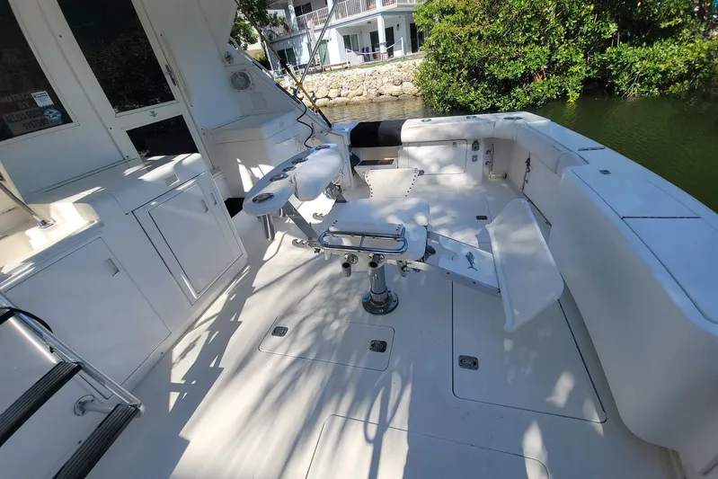 Trophy Hunter Yacht Photos Pics 1989 Bertram 50 Convertible boat deck with fishing chair and storage compartments.