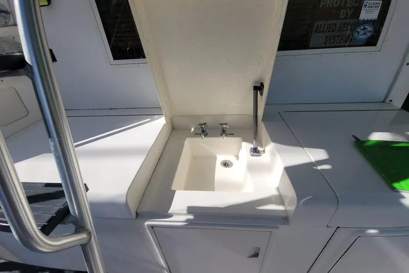 Trophy Hunter Yacht Photos Pics 1989 Bertram 50 Convertible yacht sink area with faucet and storage.