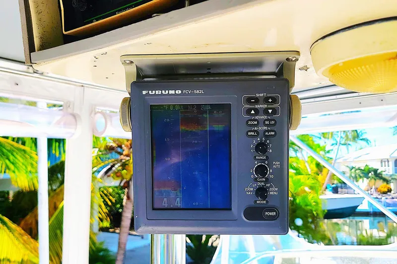 Trophy Hunter Yacht Photos Pics Fishfinder display on 1989 Bertram 50 Convertible boat, surrounded by tropical scenery.