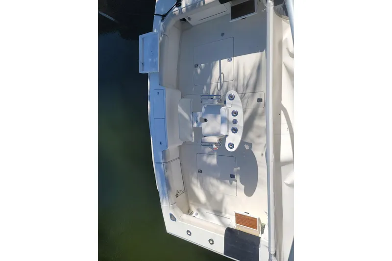 Trophy Hunter Yacht Photos Pics 1989 Bertram 50 Convertible boat deck, featuring fishing chair and storage compartments.