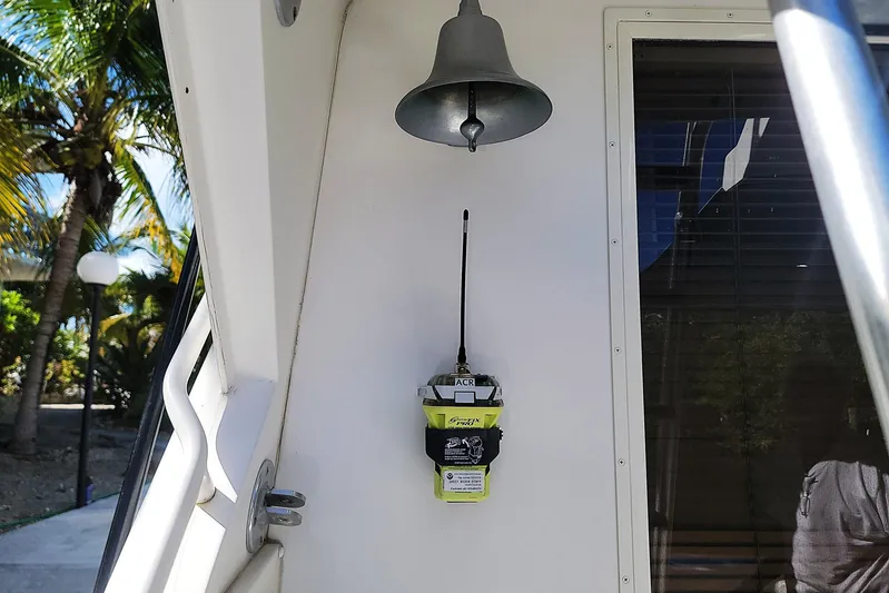 Trophy Hunter Yacht Photos Pics 1989 Bertram 50 Convertible boat with emergency beacon and bell, tropical background.