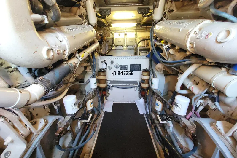 Trophy Hunter Yacht Photos Pics Engine room of a 1989 Bertram 50 Convertible yacht, showcasing mechanical components.